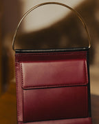 "Cartier" 80's Sculptural ring-handle leather wallet