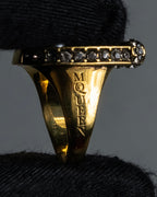 "Alexandar McQueen" Horseshoe motif red stone top ring