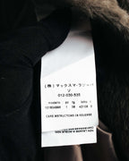 内側に配された品質表示タグを写したカット。周囲には光沢のある裏地と、密度のある滑らかな毛並みのファー調袖口が確認できます。