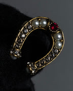 "Alexandar McQueen" Horseshoe motif red stone top ring