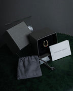 "Alexandar McQueen" Horseshoe motif red stone top ring