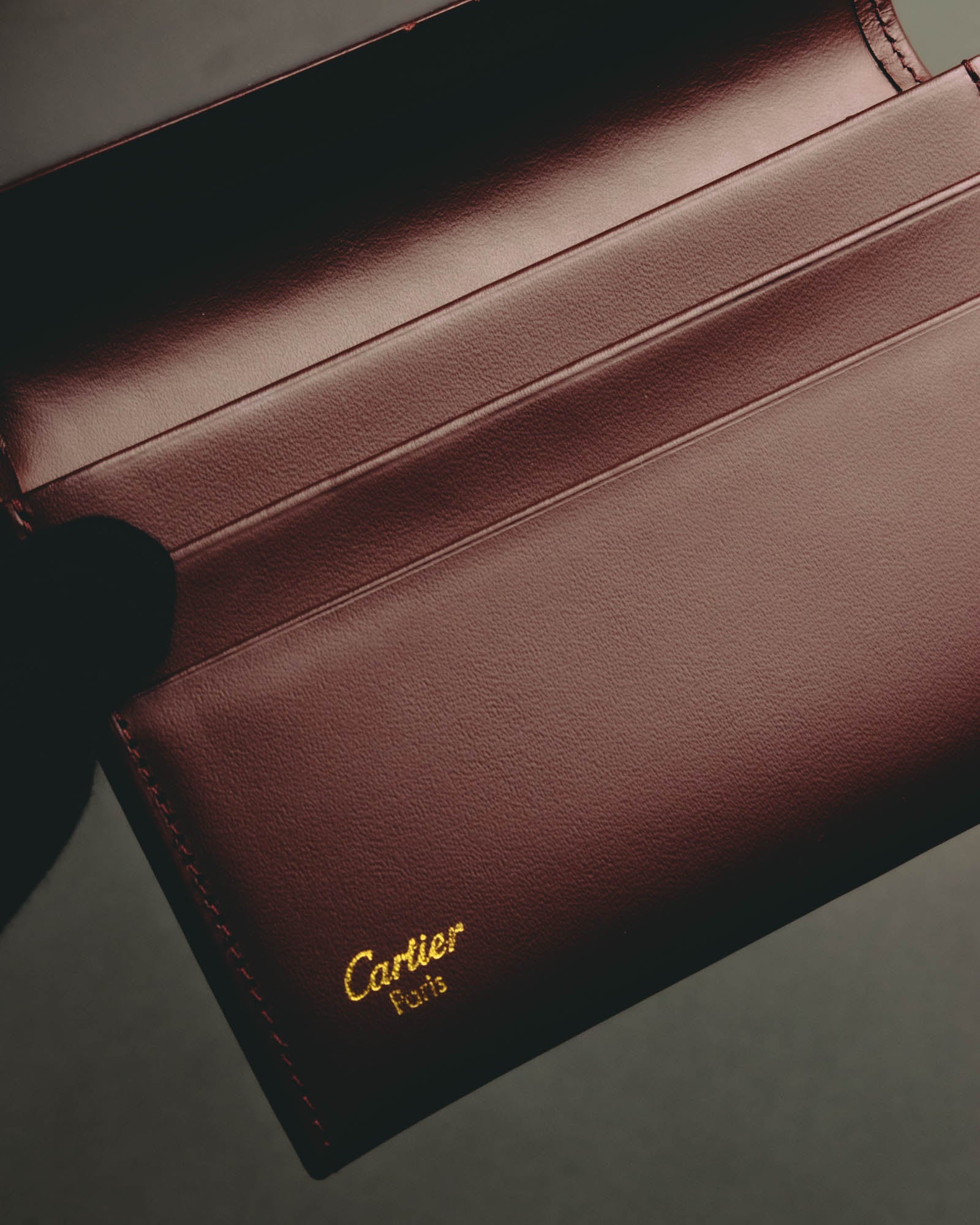 “Cartier” 90’s Must de Cartier burgundy embossed leather bifold wallet