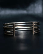 “PHILIPPE AUDIBERT” Crossed 5 line silver bangle