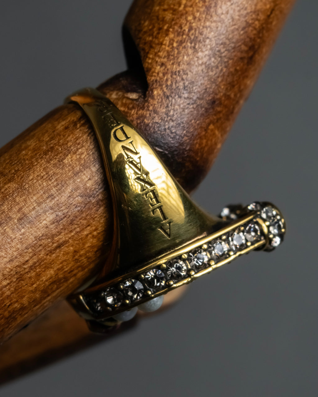 "Alexandar McQueen" Horseshoe motif red stone top ring