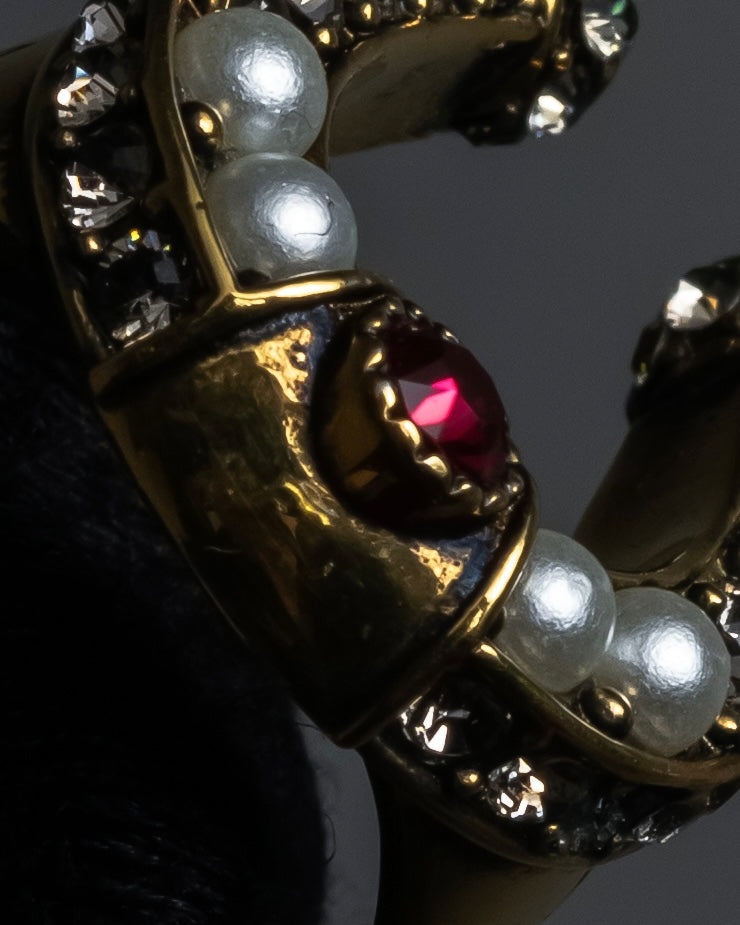 "Alexandar McQueen" Horseshoe motif red stone top ring